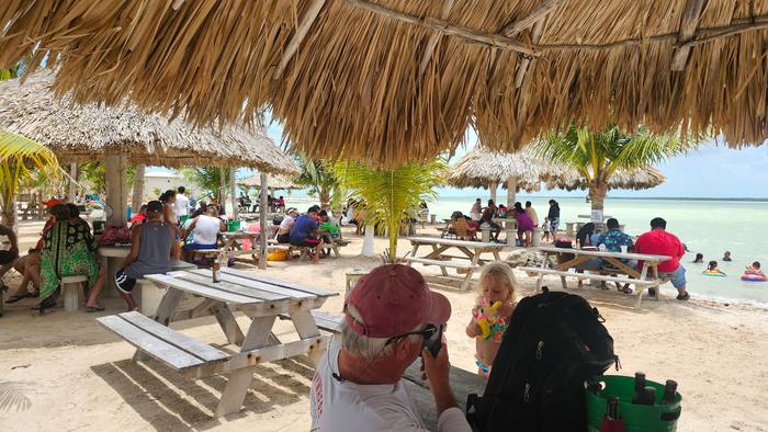 Owners and visitors under the palapas